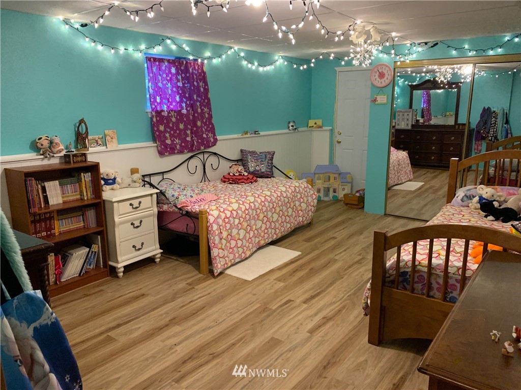 1518 South 28th Street Renton, WA 98055 - Photo 10 of 21 a bedroom with furniture and a wooden floor