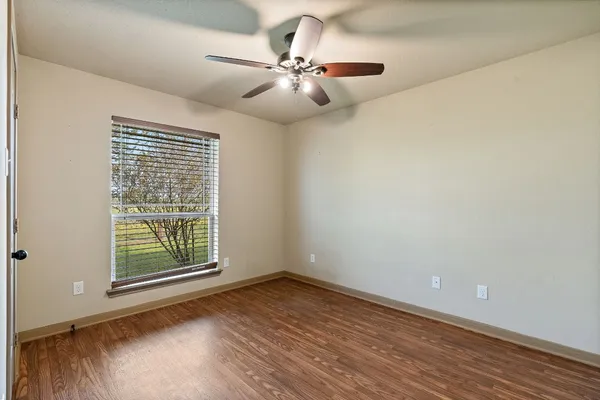 a bathroom with a granite countertop sink a toilet and a mirror