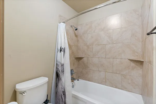 a bathroom with a sink a mirror a toilet and a mirror