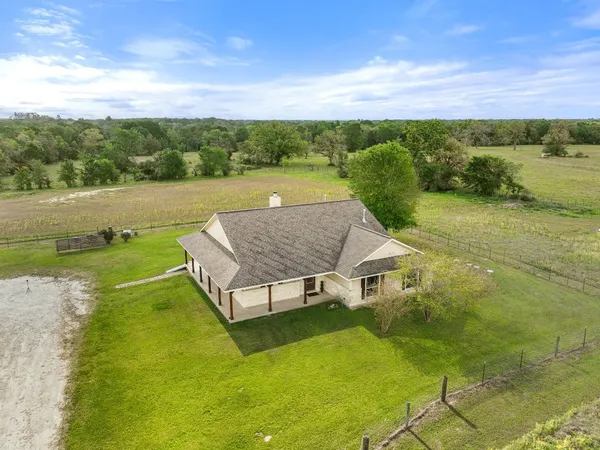a view of a house with a yard and a swimming pool