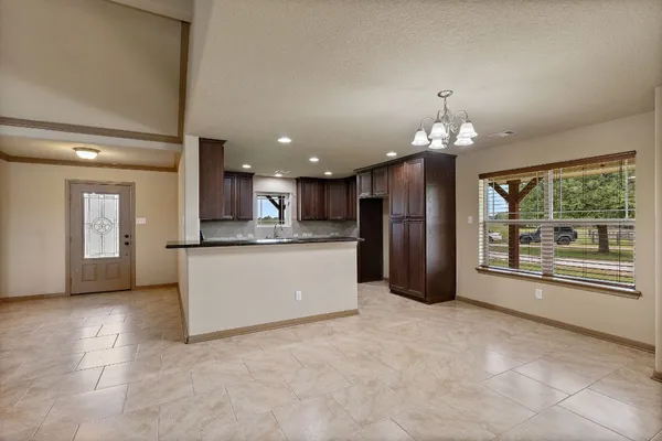 a view of a kitchen with a refrigerator a microwave and a sink