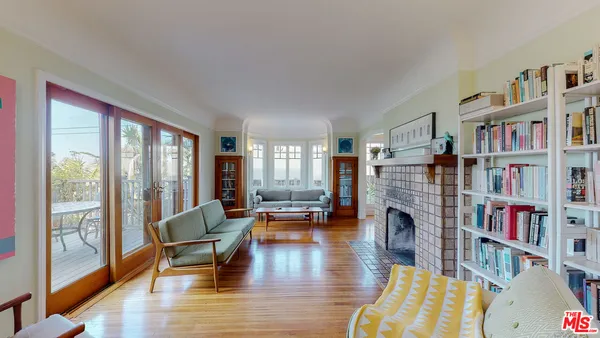 a living room with fireplace furniture and a book shelf