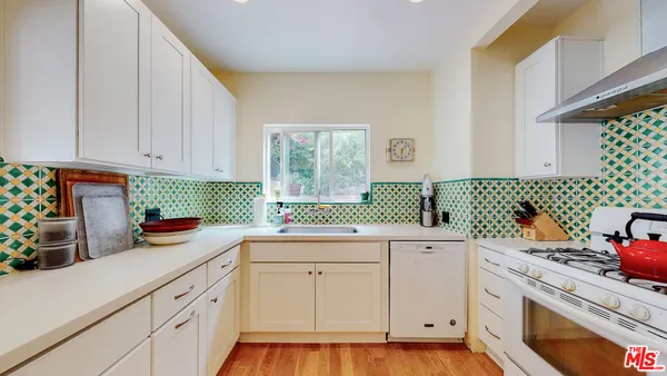 a kitchen with a sink cabinets and window