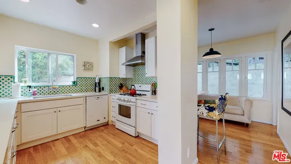 a kitchen that has a sink and a stove in it