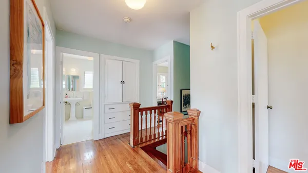 a view of a hallway with entryway wooden floor and front door