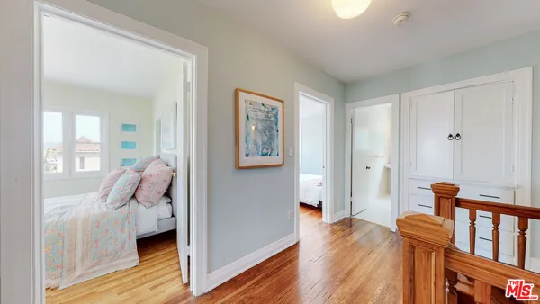 a bedroom with furniture and wooden floor