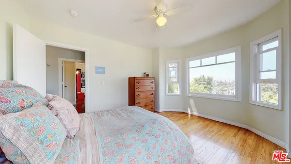a bedroom with a bed dresser and a window