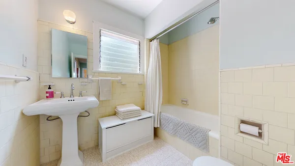 a bathroom with a sink mirror toilet and bathtub