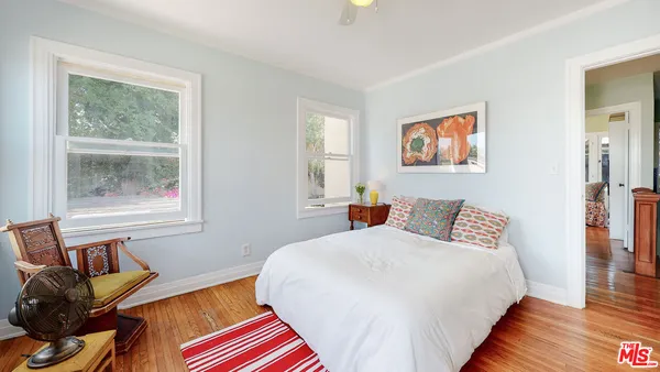 a bedroom with bed and a window