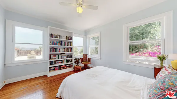 a bedroom with furniture and a book shelf