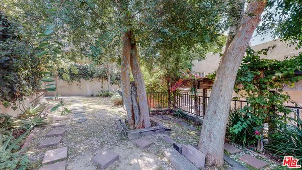 a view of a house with a tree and a yard