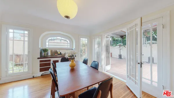 a view of a a dining room with furniture window and wooden floor