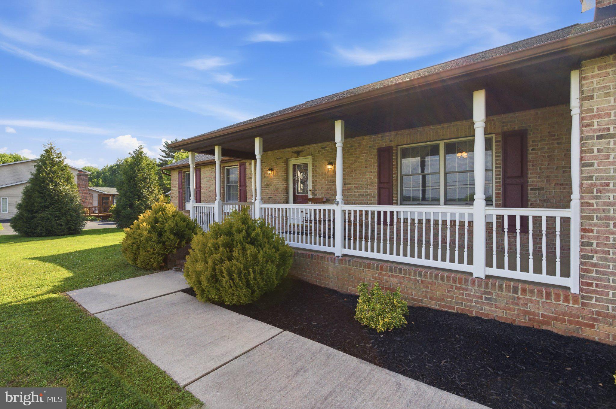 18310 Upper Beckleysville Road Hampstead, MD 21074 - Photo 6 of 67 Charming porch with lush greenery.