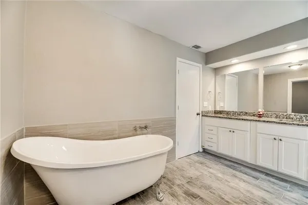 a bathroom with a bathtub and a sink