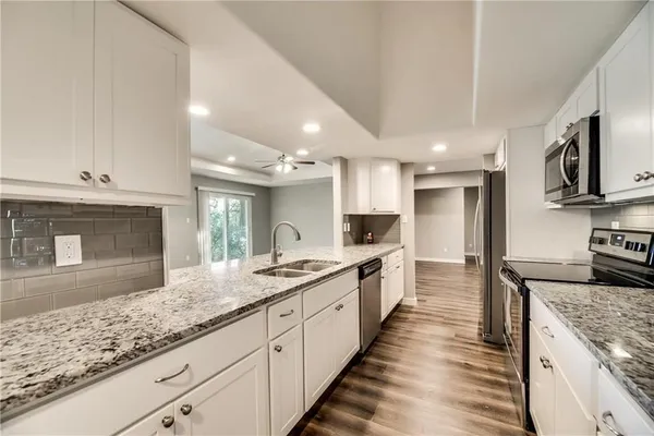 a large kitchen with granite countertop lots of counter top space