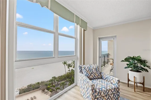 a bedroom with a bed couch and ceiling fan