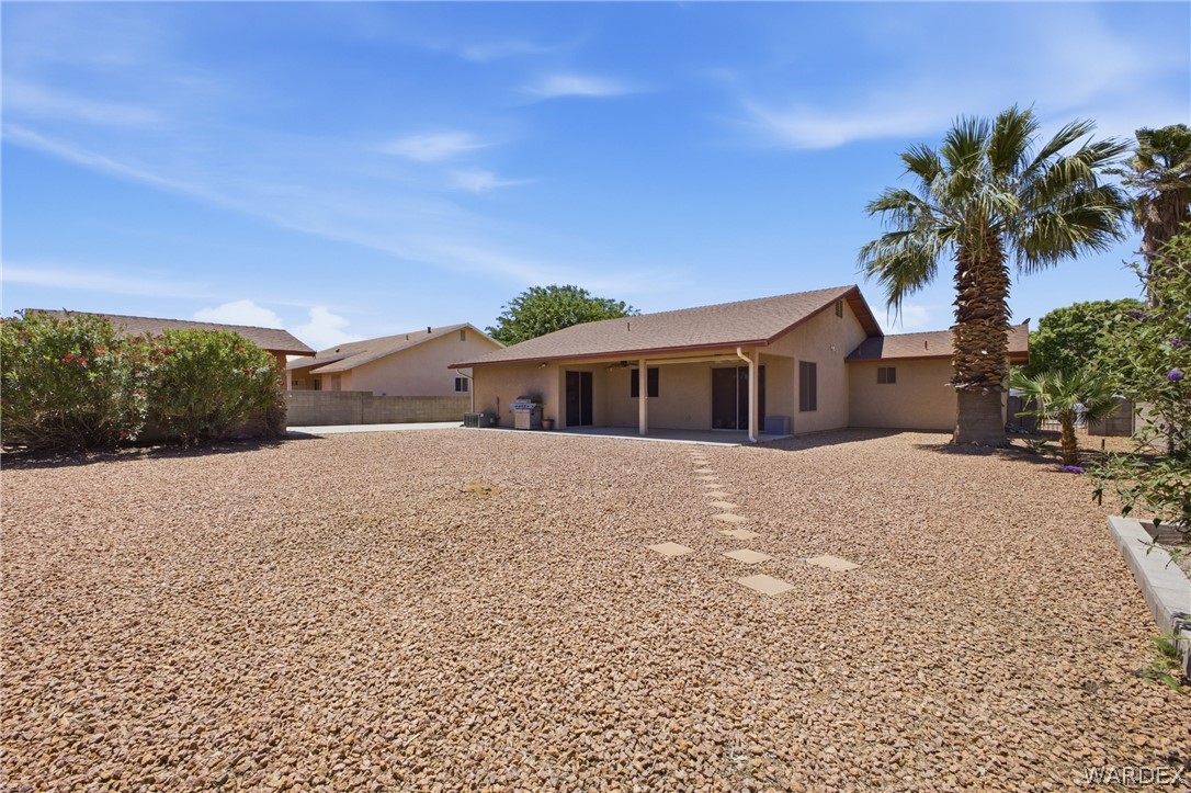 3918 North Eagle Rock Road Kingman, AZ 86409 - Photo 34 of 44 a front view of house with yard and trees around