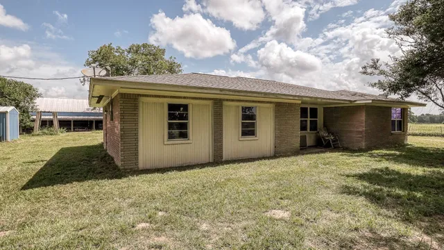 a white house that has a tree in front of it