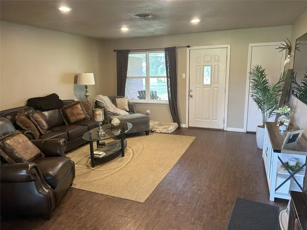 a kitchen that has a lot of white cabinets and stainless steel appliances