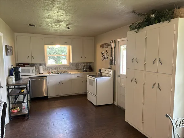 a view of a room with a table and chairs