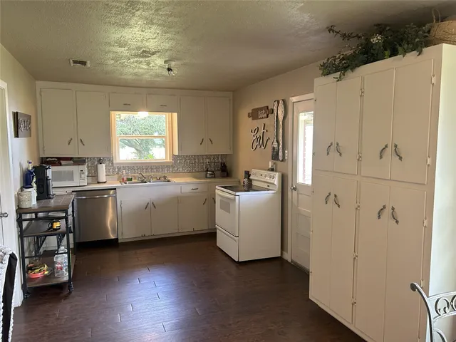 a view of a room with a table and chairs