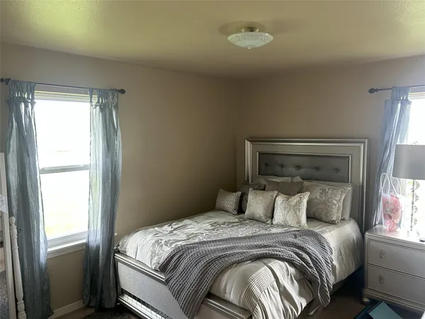a bed room with a bed and a window