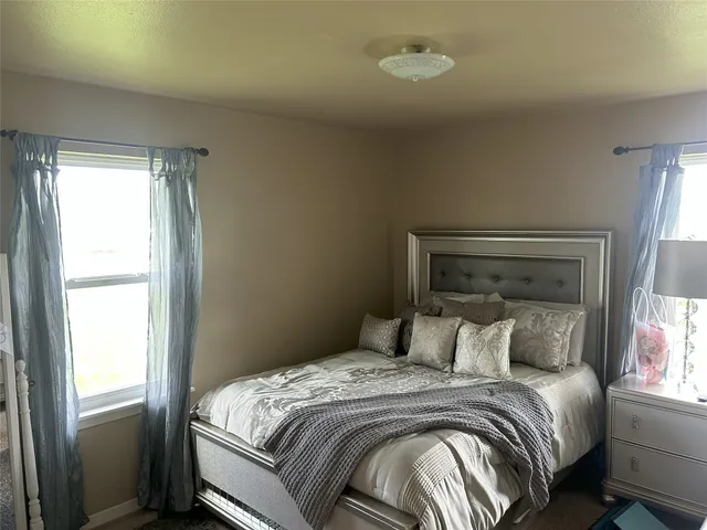 a bed room with a bed and a window