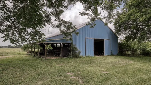 a view of a house with a yard and tree