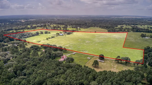 an aerial view of a house with a swimming pool
