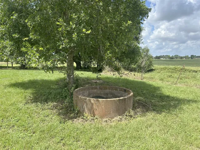 an aerial view of a residential houses with outdoor space and tennis court