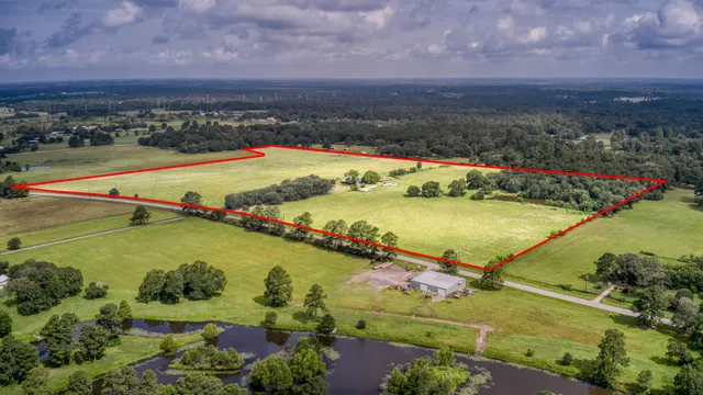 an aerial view of ocean and residential houses with outdoor space