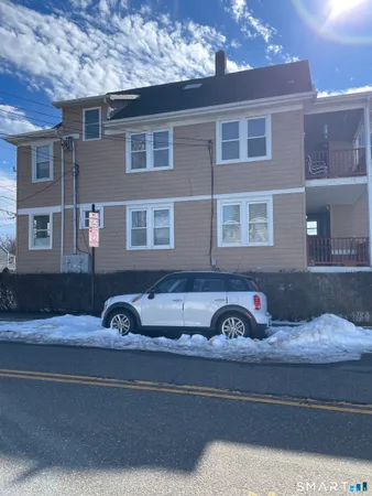 a front view of a house with parking space