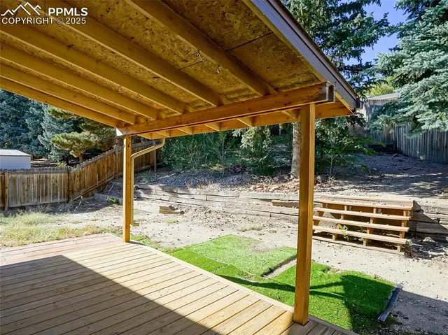 a backyard of a house with wooden fence