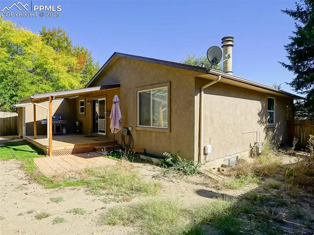 a view of a patio with a table and chairs under an umbrella