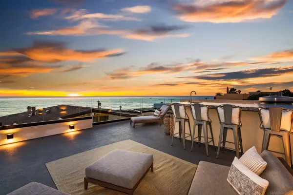 a view of a terrace with lawn chairs and wooden floor