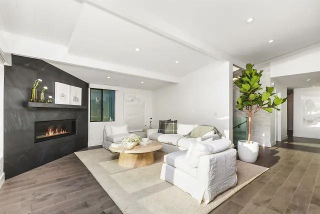 a living room with furniture fireplace and a fireplace