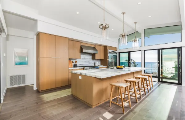 a large kitchen with kitchen island a large counter space a sink appliances and cabinets