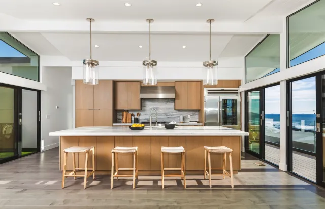 a kitchen with cabinets and chairs