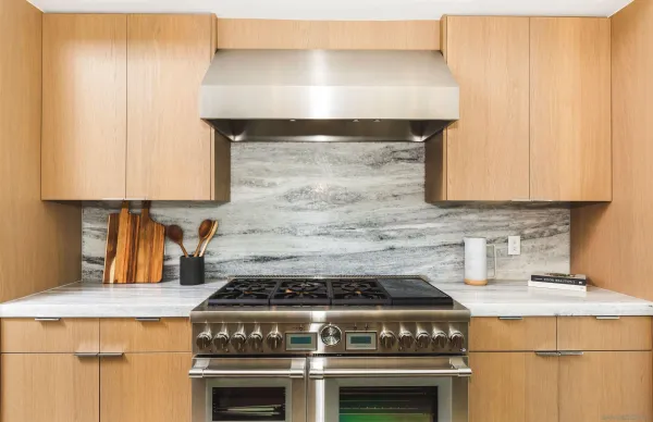 a stove top oven sitting inside of a kitchen