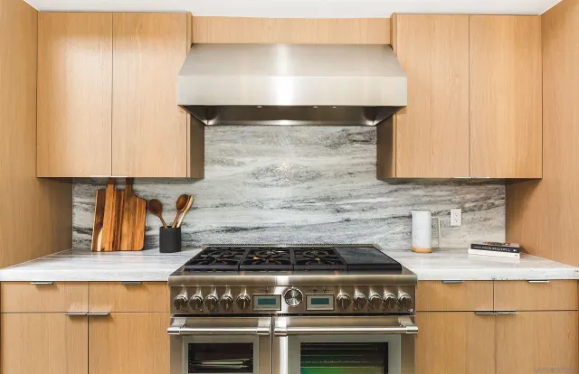 a stove top oven sitting inside of a kitchen