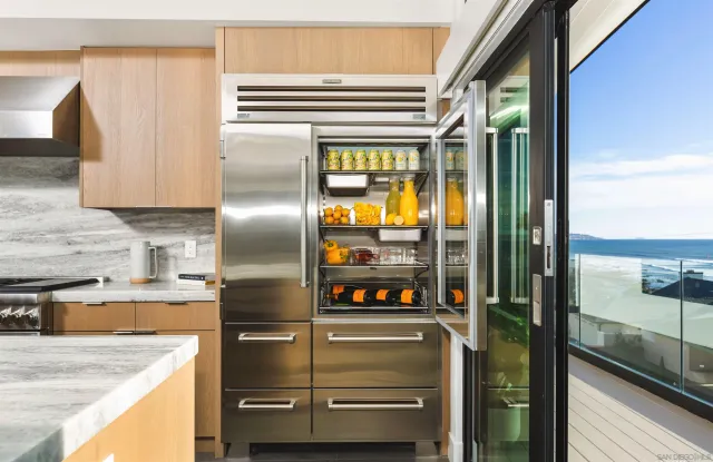 a kitchen with a refrigerator and a sink