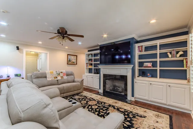 a living room with furniture and a fireplace