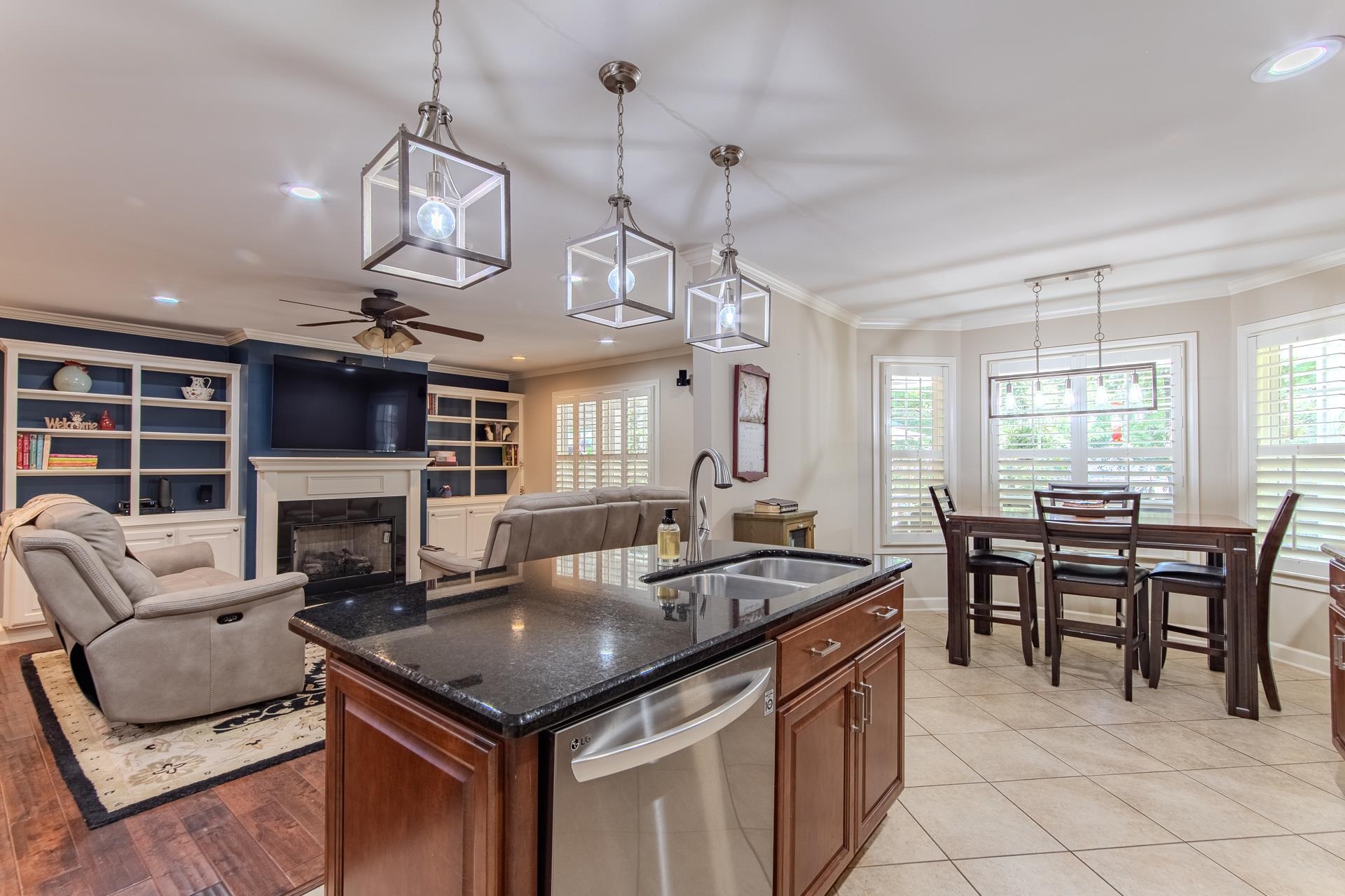 115 Partridge Lane Savannah, TN 38372 - Photo 19 of 40 a kitchen with a stove center island dining table and chairs
