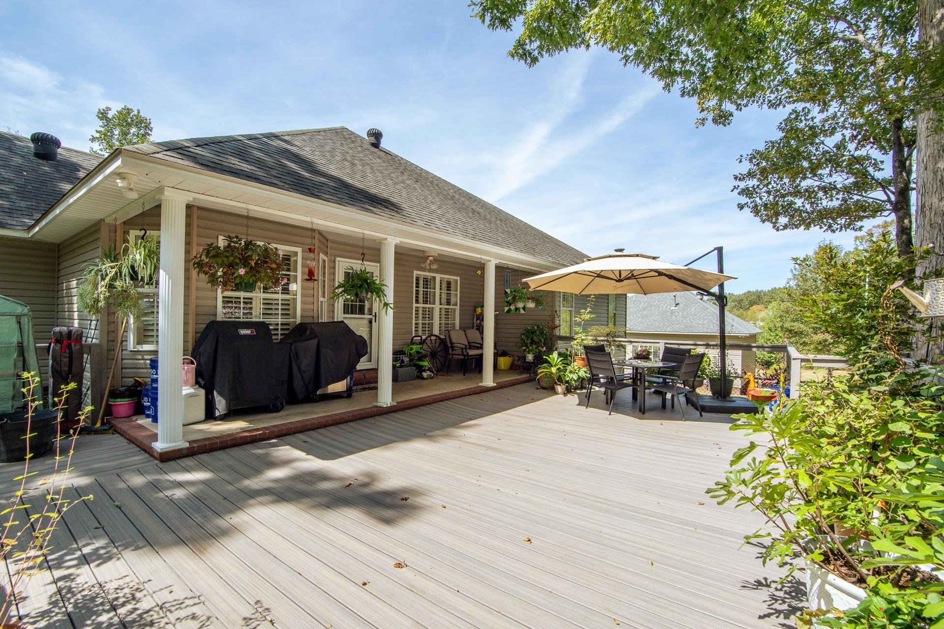 115 Partridge Lane Savannah, TN 38372 - Photo 23 of 40 a view of a patio with a table and chairs under an umbrella