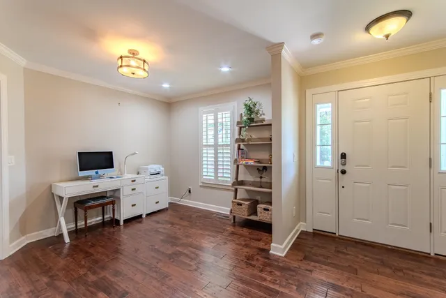 a view of work space with wooden floor and furniture