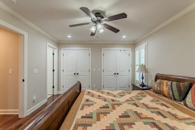 a bedroom with a bed and a chandelier