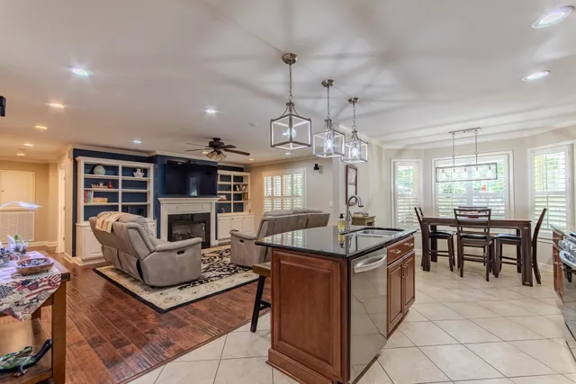 a living room with fireplace furniture and a chandelier