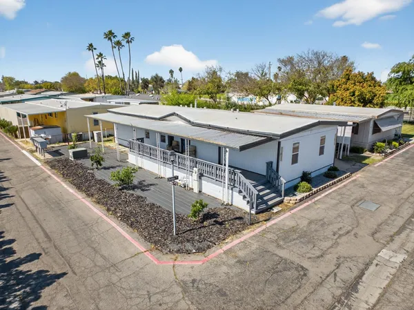 a aerial view of a house with a yard and lake view