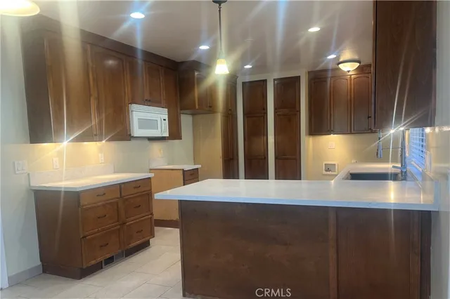 a kitchen with a sink and a large mirror