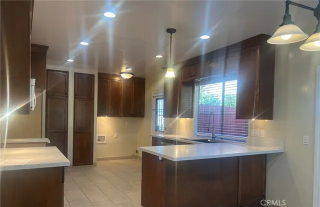 a kitchen with stainless steel appliances kitchen island a refrigerator and a sink
